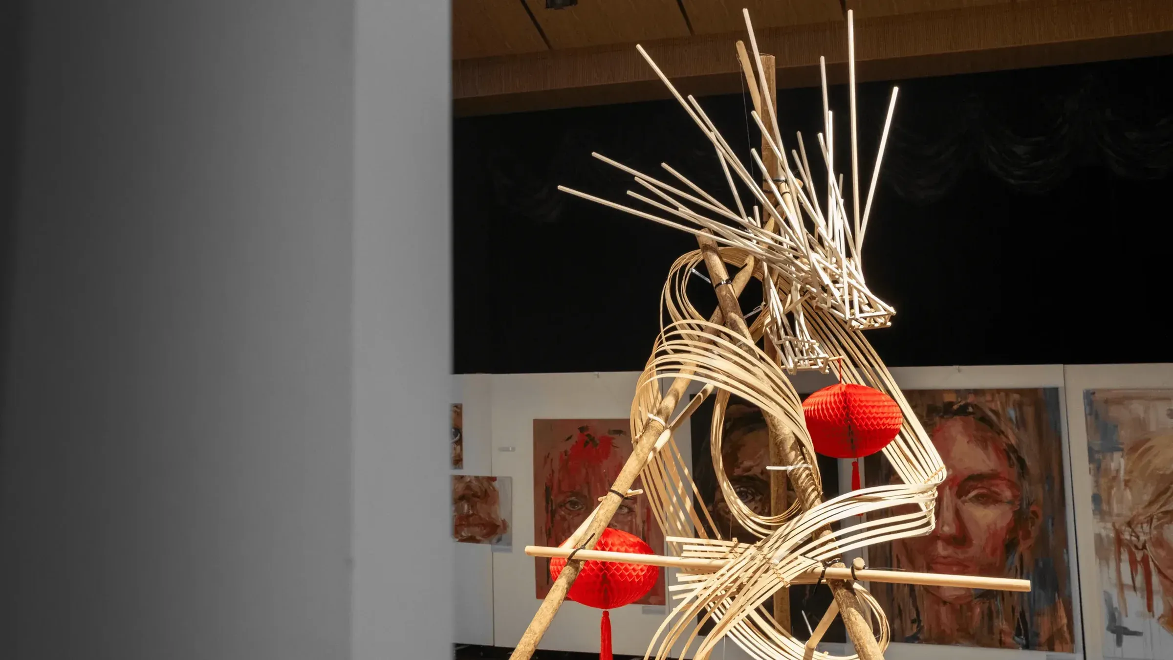 魚躍龍門 Metamorphosis: a bamboo dragon mid-leap through red paper lanterns, in the exhibition hall