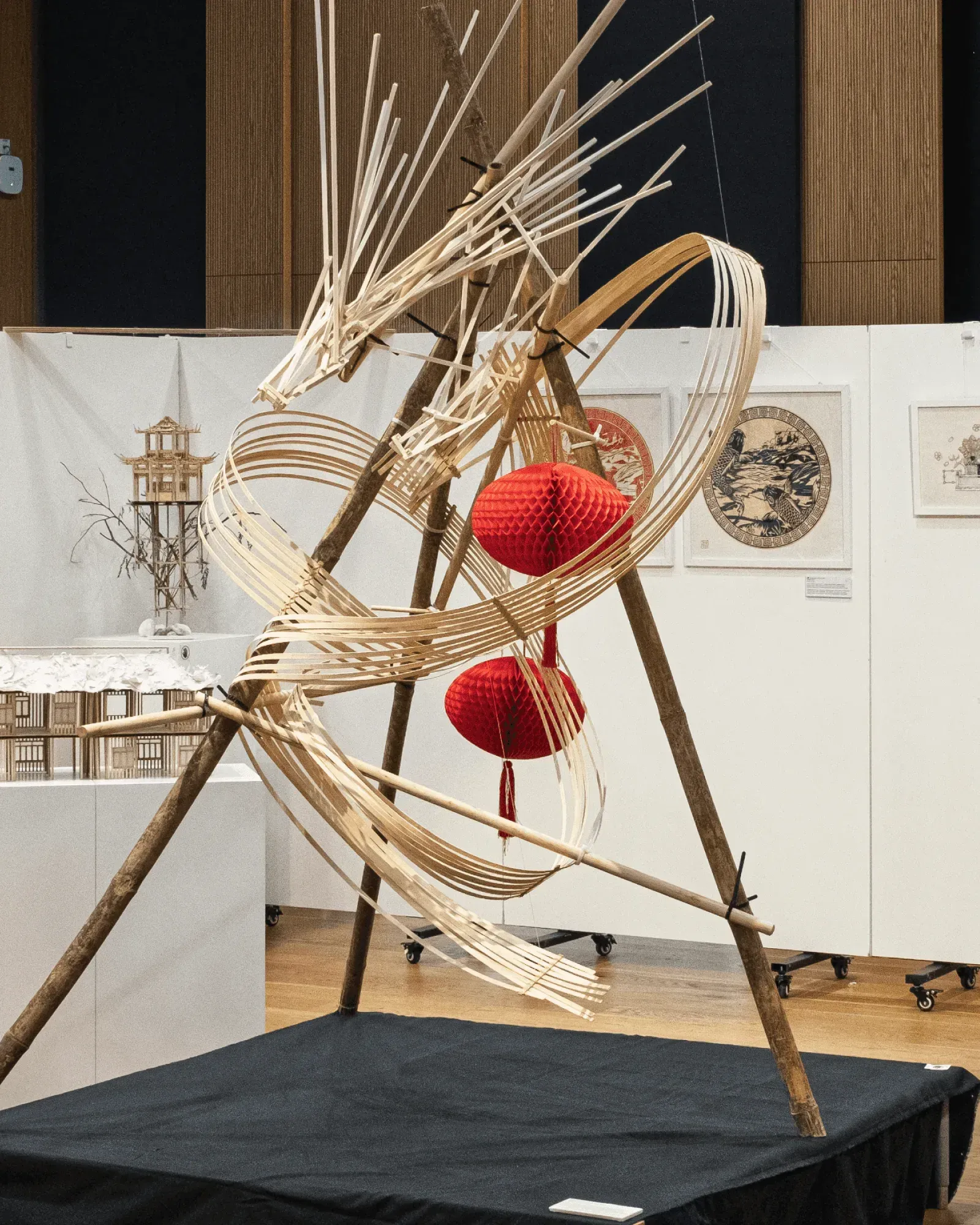魚躍龍門 Metamorphosis, March 2025, bamboo and balsa, 150 × 150 × 230 cm: the dragon on its black plinth with red lanterns
